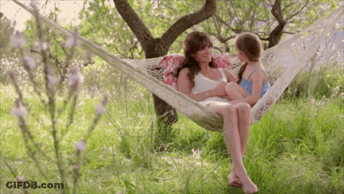 Woman In Hammock Holding Little Girl GIF