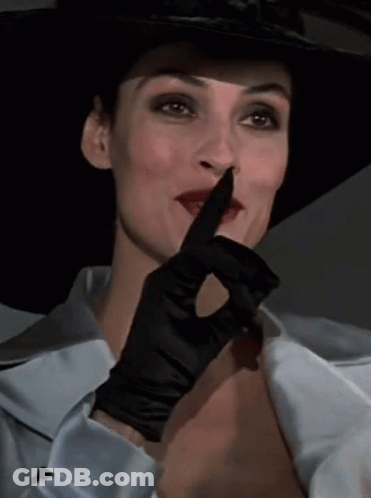 Woman In Hat And Black Glove Shushing GIF