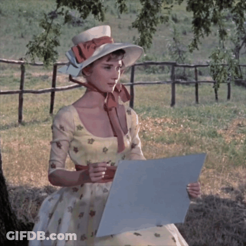 Woman In Hat And Dress Holding Paper GIF
