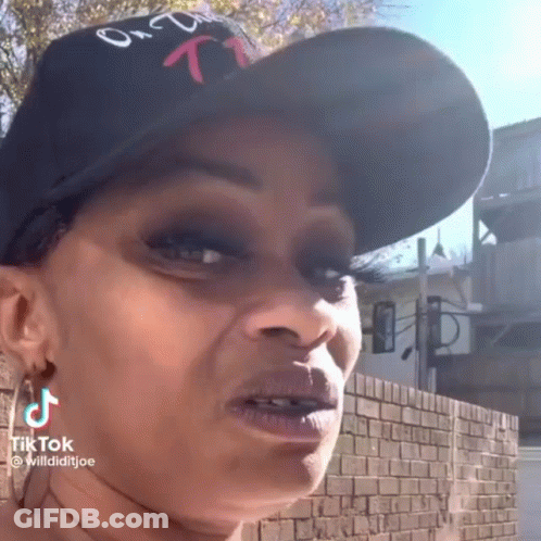 Woman In Hat And Earrings Making Funny Face GIF