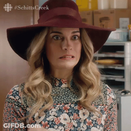 Woman In Hat And Floral Shirt Making Funny Face GIF