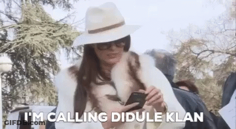 Woman In Hat And Fur Coat Calling Didule Klan GIF