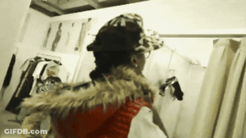 Woman In Hat And Fur Vest In Dressing Room GIF