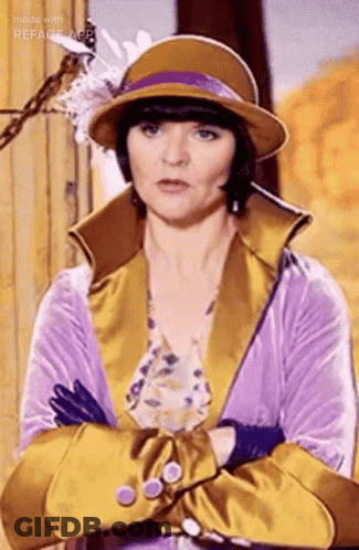 Woman In Hat And Gloves Standing With Arms Crossed GIF