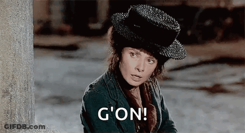 Woman In Hat And Jacket By Wall Saying G'on GIF