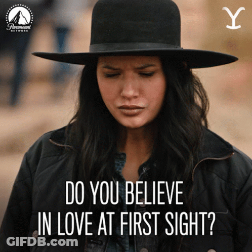 Woman In Hat And Jacket Saying Do You Believe In Love At First Sight GIF