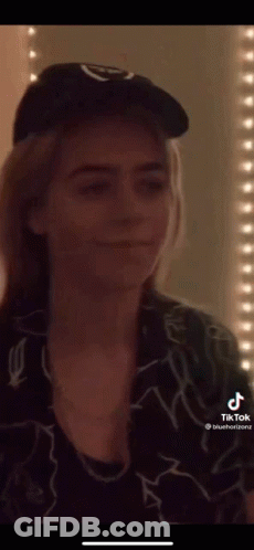 Woman In Hat And Necklace Before Blue Light GIF