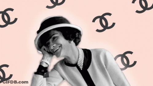 Woman In Hat And Pearl Necklace Surrounded By Chanel Logos GIF