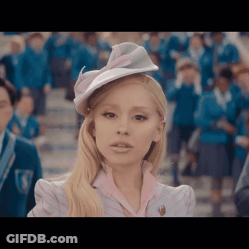 Woman In Hat And Pink Shirt Before Crowd GIF