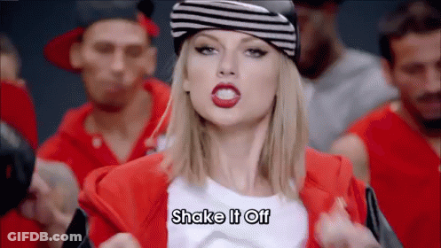 Woman In Hat And Red Jacket Says Shake It Off GIF
