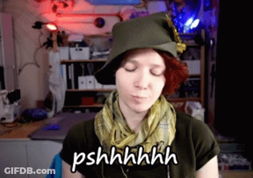 Woman In Hat And Scarf Says Pshhhhhh GIF
