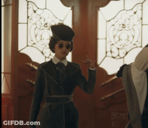 Woman In Hat And Sunglasses At Door GIF