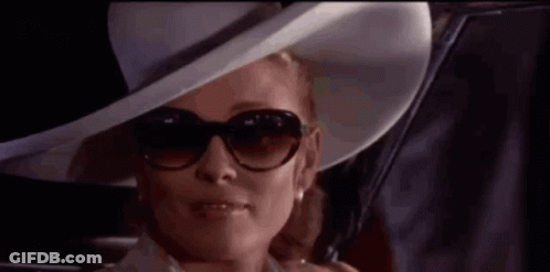 Woman In Hat And Sunglasses Looking Out Car Window GIF