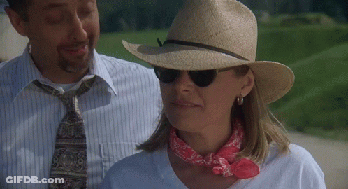 Woman In Hat And Sunglasses Next To Man GIF