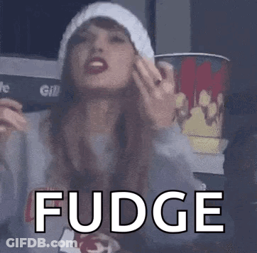 Woman In Hat And Sweater Holding Bucket Of Popcorn GIF