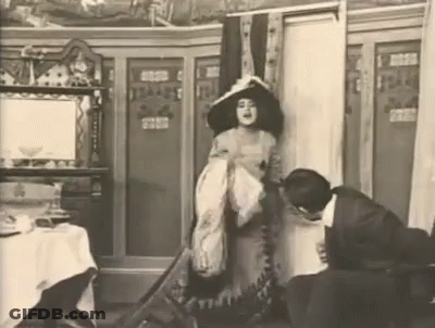 Woman In Hat Beside Man Black And White GIF