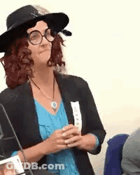 Woman In Hat Glasses And Blue Shirt Sitting GIF