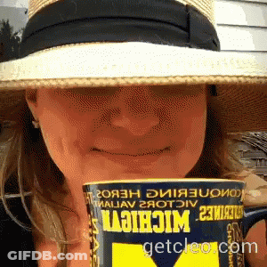 Woman In Hat Holding Can Of Michigan GIF