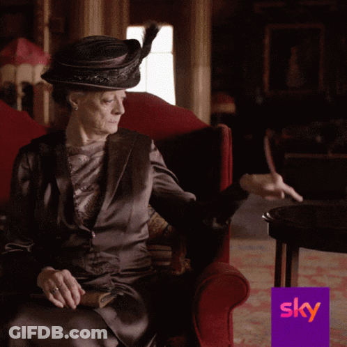 Woman In Hat Sitting In Red Chair With Sky Logo GIF