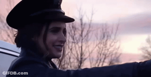 Woman In Hat Smiling In Back Of Car GIF