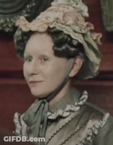 Woman In Hat With Ruffles And Bow GIF