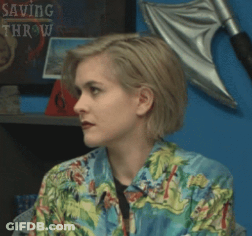 Woman In Hawaiian Shirt In Front Of Saving Throw Shelf GIF