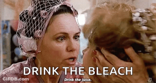 Woman In Head Scarf Talking And Drinking Bleach GIF