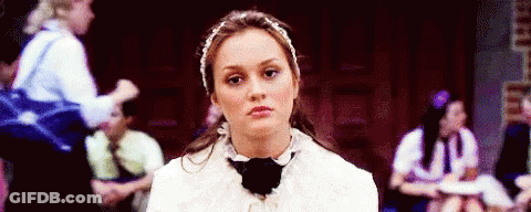 Woman In Headband And Bow Tie Sitting With Group GIF