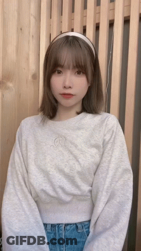 Woman In Headband And Grey Sweatshirt GIF
