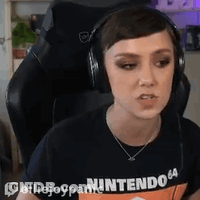 Woman In Headphones And Nintendo 64 Shirt Sitting In Chair GIF