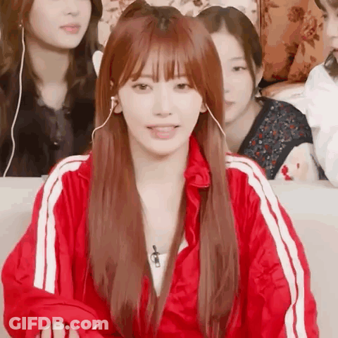 Woman In Headphones And Red Jacket On Couch GIF