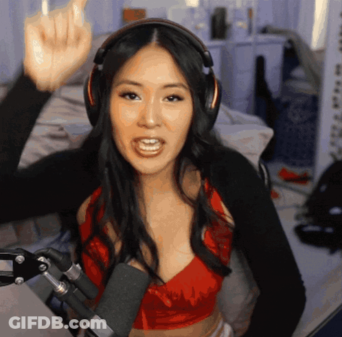 Woman In Headphones And Red Top Giving Middle Finger At Microphone GIF