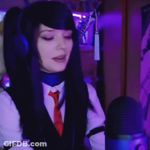 Woman In Headphones And Tie Singing Into Blue Microphone GIF