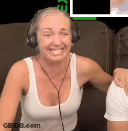 Woman In Headphones And White Tank Top Smiling In Front Of Screen Saying Ke GIF