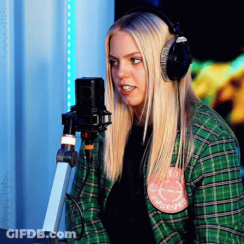 Woman In Headphones At Microphone With Forever Patch GIF