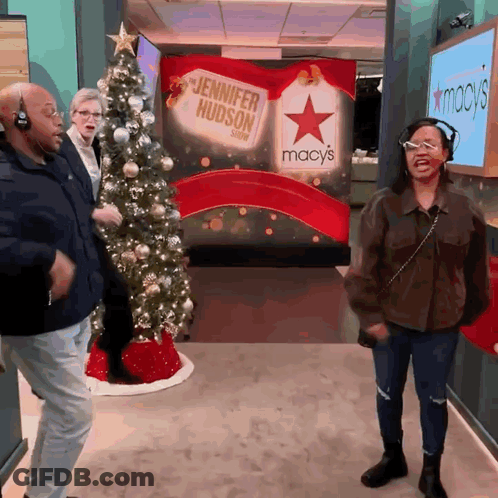 Woman In Headphones Dancing In Front Of Jennifer Hudson Sign GIF