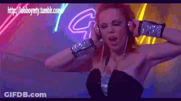 Woman In Headphones Dancing In Front Of Neon Sign Saying G GIF