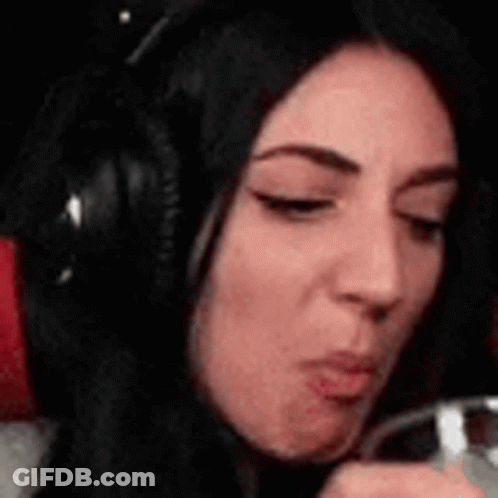 Woman In Headphones Drinking From Glass Making Face GIF