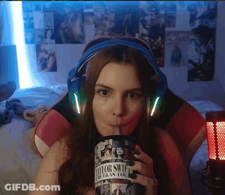 Woman In Headphones Drinking From Taylor Swift Cup GIF