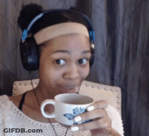 Woman In Headphones Holding Cup Of Tea GIF