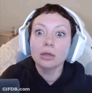 Woman In Headphones Making Funny Face Sitting In Chair GIF