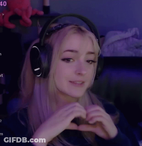 Woman In Headphones Making Heart With Hands GIF