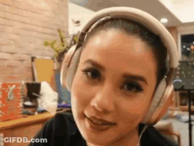 Woman In Headphones Rolls Her Eyes GIF