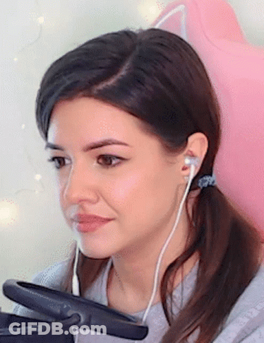 Woman In Headphones Sitting In Pink Chair GIF
