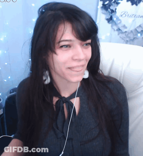 Woman In Headphones Smiling By Brasserie Wreath GIF