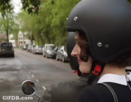 Woman In Helmet And Sunglasses Riding Scooter GIF