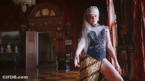 Woman In High Slit Dress Covering Nose GIF