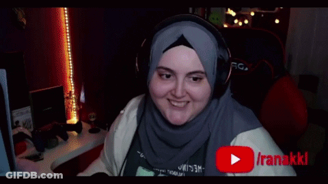 Woman In Hijab And Headphones Smiling At Iranakikiclips Screen GIF