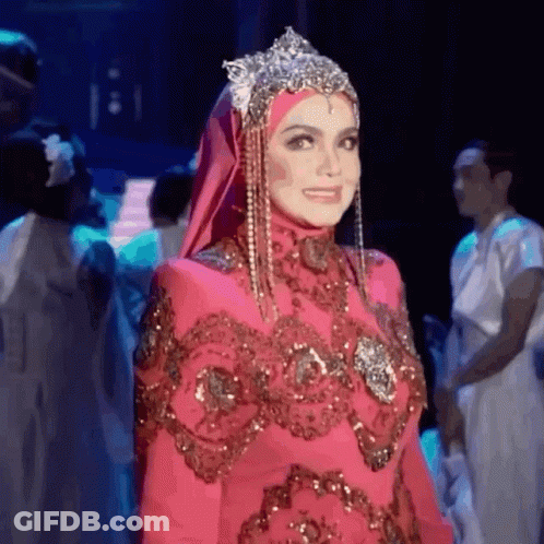Woman In Hijab And Pink Dress Standing On Stage GIF