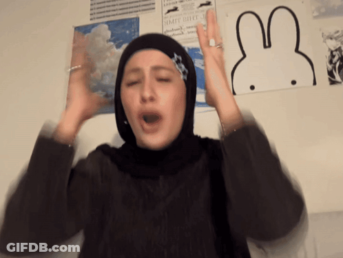 Woman In Hijab Making Funny Face Beside Rabbit Picture GIF